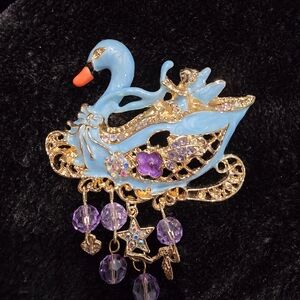 Elegant Gold and Blue Swan Brooch with Purple Accents